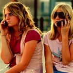 two girls on cell phones Two girls chatting on cell phones